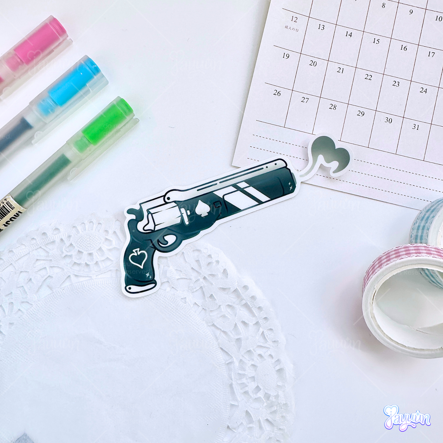 An Ace of Spades inspired sticker photographed on a white desk background.