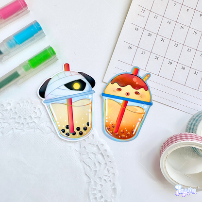 Lucky and Zucker-inspired boba stickers photographed on a white desk background.