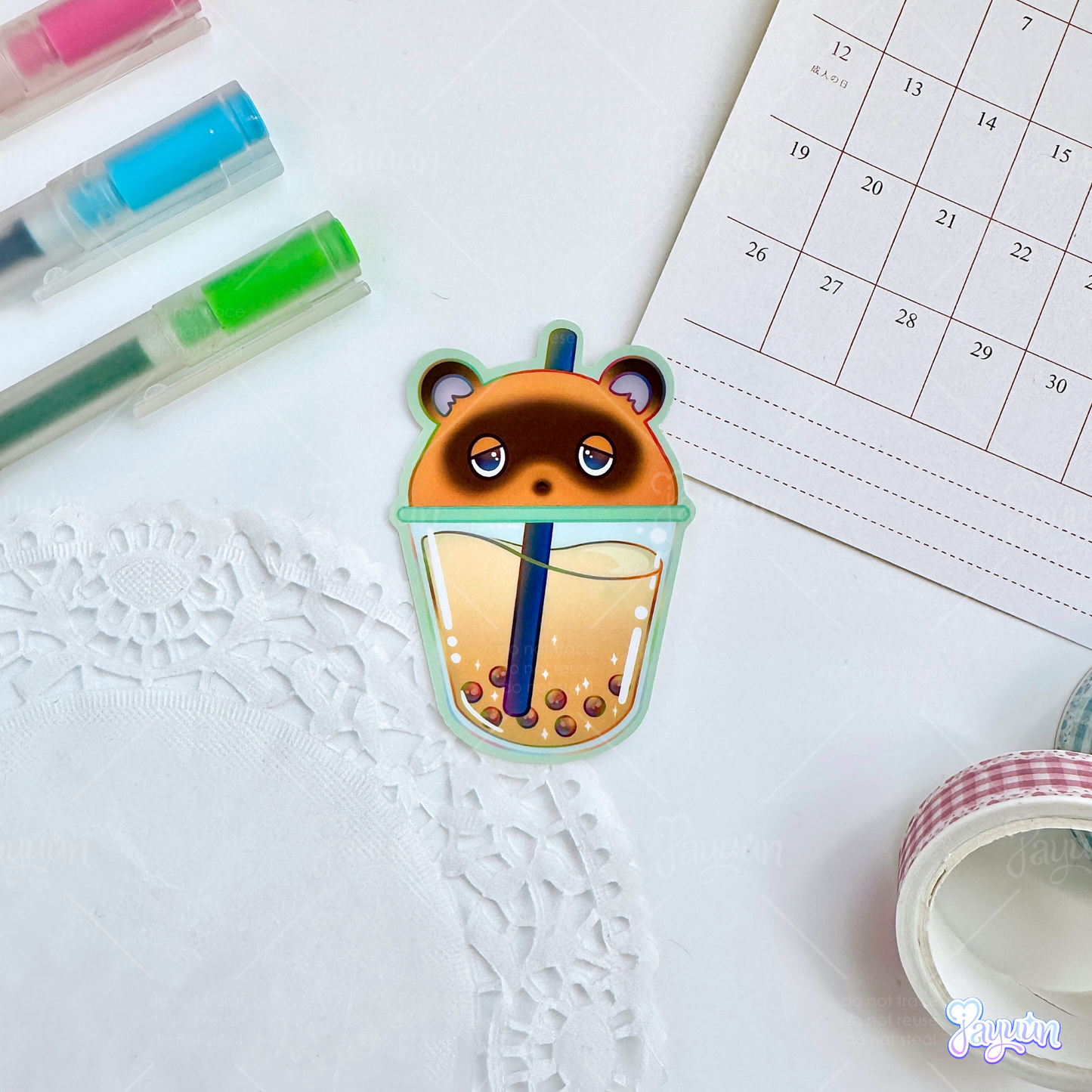 Tom Nook-inspired boba sticker photographed on a white desk background.