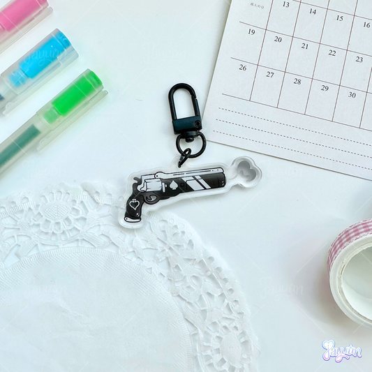 An Ace of Spades-inspired keychain photographed on a white desk background.