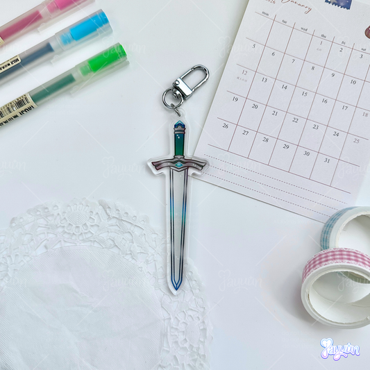 A Dull Blade-inspired acrylic charm photographed on a white desk background.