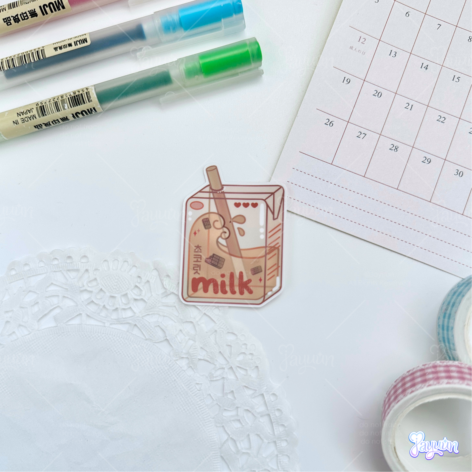 Brown chocolate milk carton sticker photographed on a white desk background.