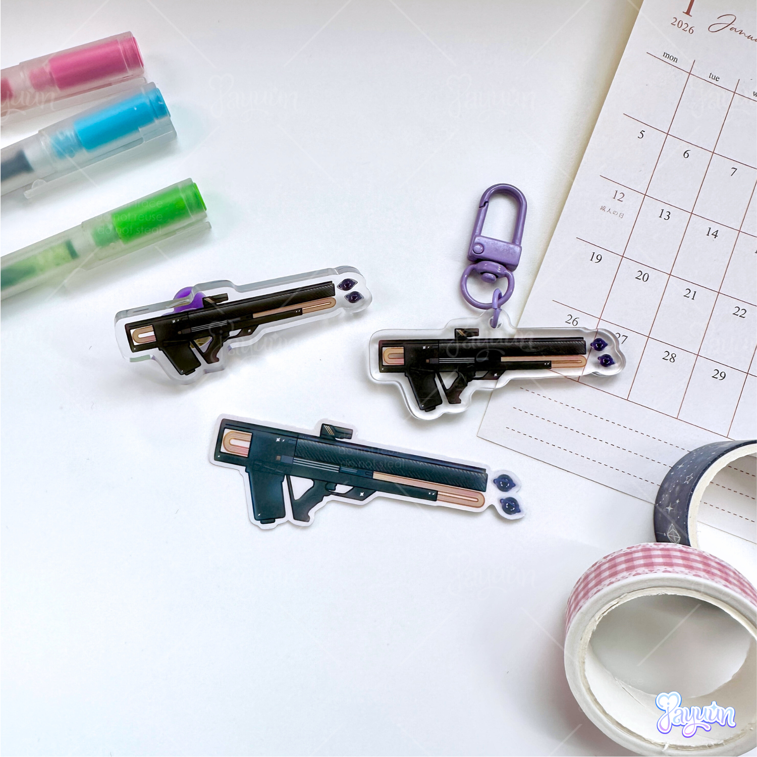 A void pulse rifle acrylic pin, void pulse rifle acrylic keychain, and void pulse rifle sticker photographed on a desk.